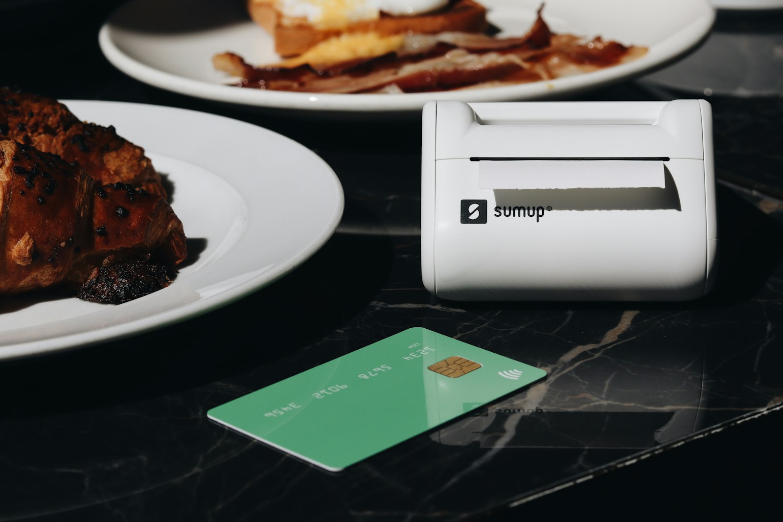 A table topped with plates of food and a credit card